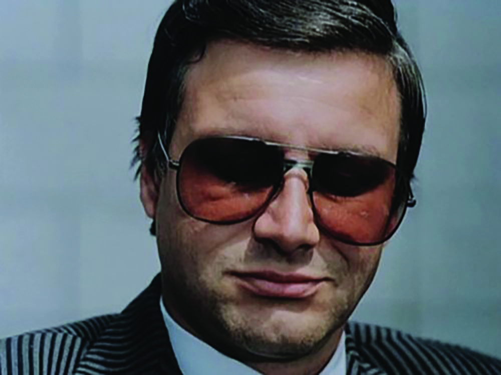 A middle-aged man in large sunglasses.