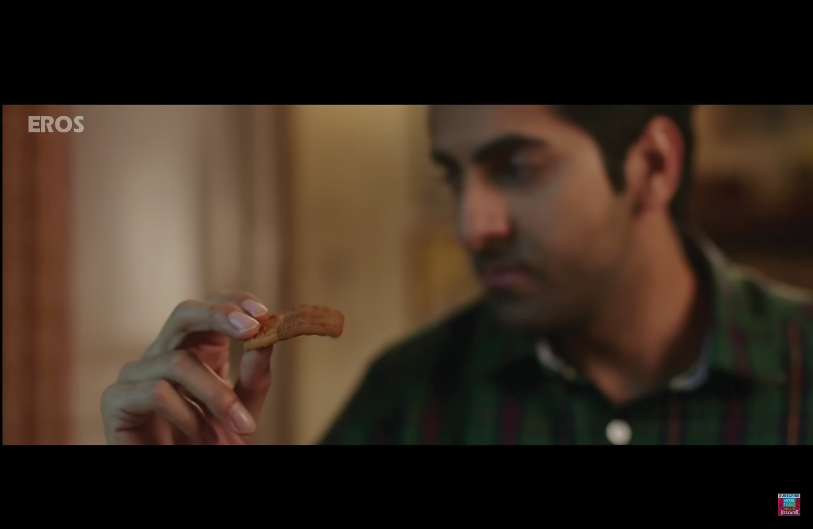 Mudit holds up a biscuit in his fingers, which curls somewhat limply in the air.
